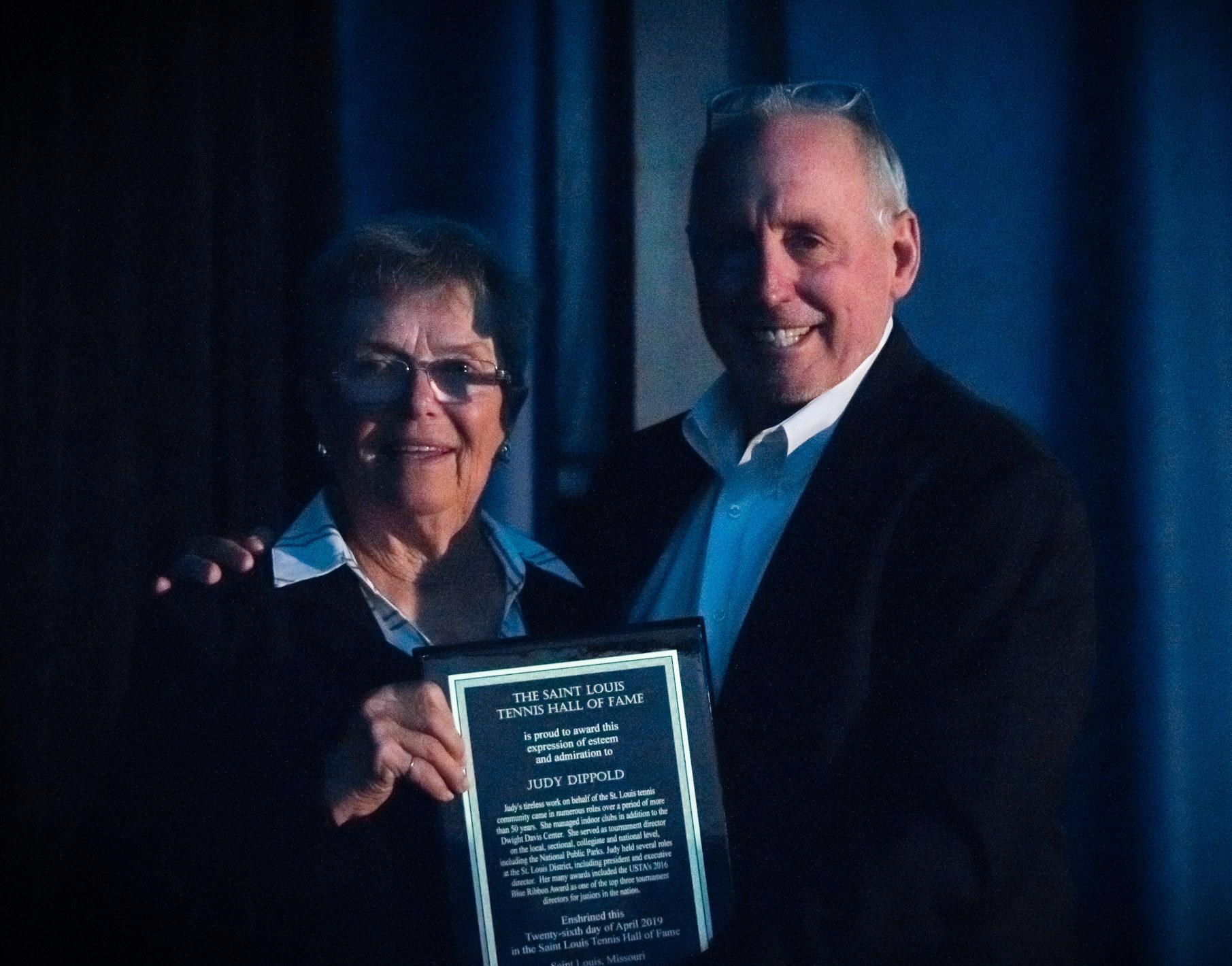 Judy Dippold accepts her plaque from Rick Randall